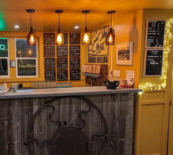 Gridiron taproom bar with pendant lights and chalkboard menus